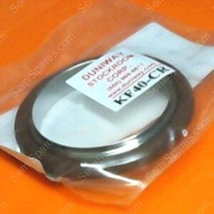 Metal circular gasket in a clear plastic bag on an orange surface.