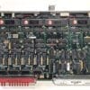 Printed circuit board densely populated with DIP ICs and a prominent red edge connector at the bottom edge.