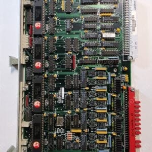 Industrial-era computer expansion card/PCB densely populated with DIP ICs, yellow capacitors and resistors, edge connector on the right for backplane mounting, mounted in a metal chassis.