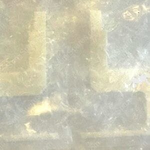 Blurred, weathered wall with pale beige rectangular patches and soft gray tones in a muted abstract texture.