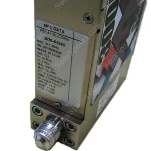 Metal industrial electronic module with a data label on its side and a knurled circular connector at the bottom front. The label appears to show manufacturing data (MFG DATA, Vishay Siliconix).