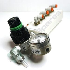 Close-up of a medical gas regulator with a round pressure gauge, tubing, and orange valve caps on a white background.