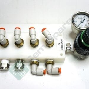 Close-up of an electrical terminal block with white fuse holders, orange caps, and a pressure gauge on the right side.
