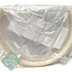 Clear plastic bag containing a large beige circular object; light-colored ring along its edge is visible, with a green label showing a white circuit-like design partially visible inside.