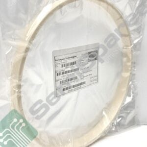 Beige circular component sealed in clear plastic packaging with a product label and barcode visible on the bag.