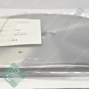 Round gray disc inside clear plastic packaging with a white shipping label and a green circuit-pattern sticker visible at the bottom edge.