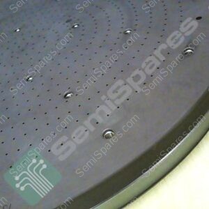 Close-up of a dark circular perforated metal plate with numerous tiny holes and visible screws around the rim; a green logo watermark sits on the surface.