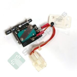 Wires and a small electronic module with red connectors and a green circuit board, partially mounted on metal hardware.
