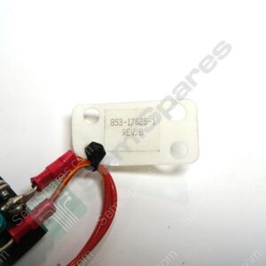 Close-up of a white plastic mounting plate with red and yellow wires attached; label reads 853-176265-1, REV. B.