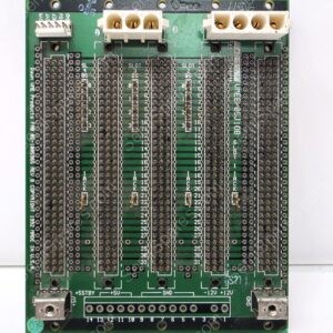 Green PC board with many empty SMD sockets and three white connectors at the top; bottom edge shows power rails labeled +5STBY, +5V, GND, -12V, +12V.