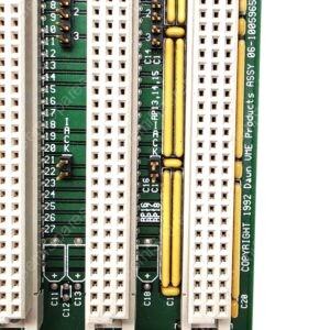 Close-up of a green motherboard edge with white pin sockets and yellow capacitors, showing circuit traces and component labels like C1, +5V, GND.
