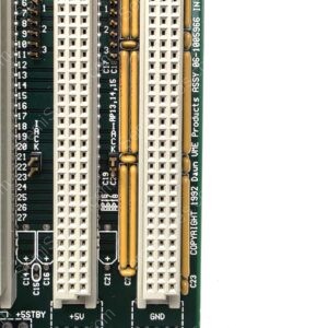 Close-up of a computer motherboard edge with white PCI/ISA-like connectors and gold-plated pins; labels +5V, GND, and BIOS-like silkscreen visible.