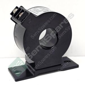 Close-up of a black circular electrical component with a small terminal block on top and mounting base, showing screws and a label