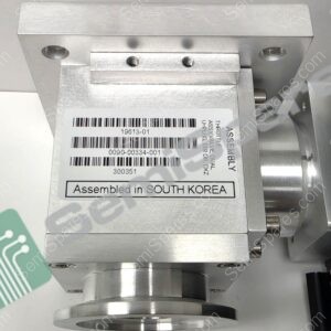 Metallic industrial component with a barcode label reading 'Assembled in SOUTH KOREA' and two threaded holes on a flat bracket surface.