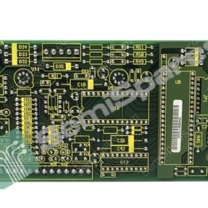 Green printed circuit board densely populated with surface-mounted and through-hole components, yellow silkscreen labels, and edge connectors on the right side, viewed from the edge (PCB assembly)