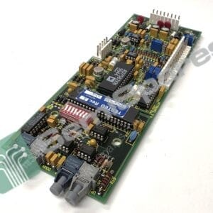 Close-up of a dense circuit board with chips, capacitors, resistors, and a right-edge connector