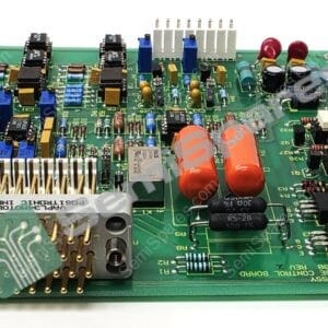 Close-up of a green printed circuit board filled with capacitors, resistors, ICs, and connectors.