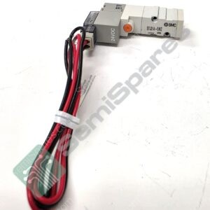 SMC pneumatic solenoid valve with a 24V DC coil and red/black wiring, shown laid on a white surface.