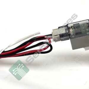 Industrial electrical component with red and black wires attached to a gray module (solenoid/valve) and an orange screw cap visible on the top right
