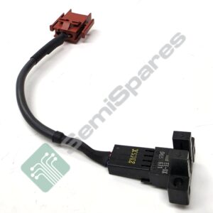 Close-up of a red rectangular automotive electrical connector attached to a black cable, showing a multi-pin housing and locking tabs.