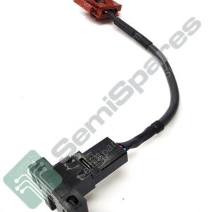 Close-up of a red plastic electrical connector attached to a black insulated cable harness, seen from above.