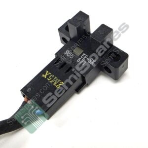 Close-up of a black plastic electronic component with a small green printed circuit board tip showing circuit traces.